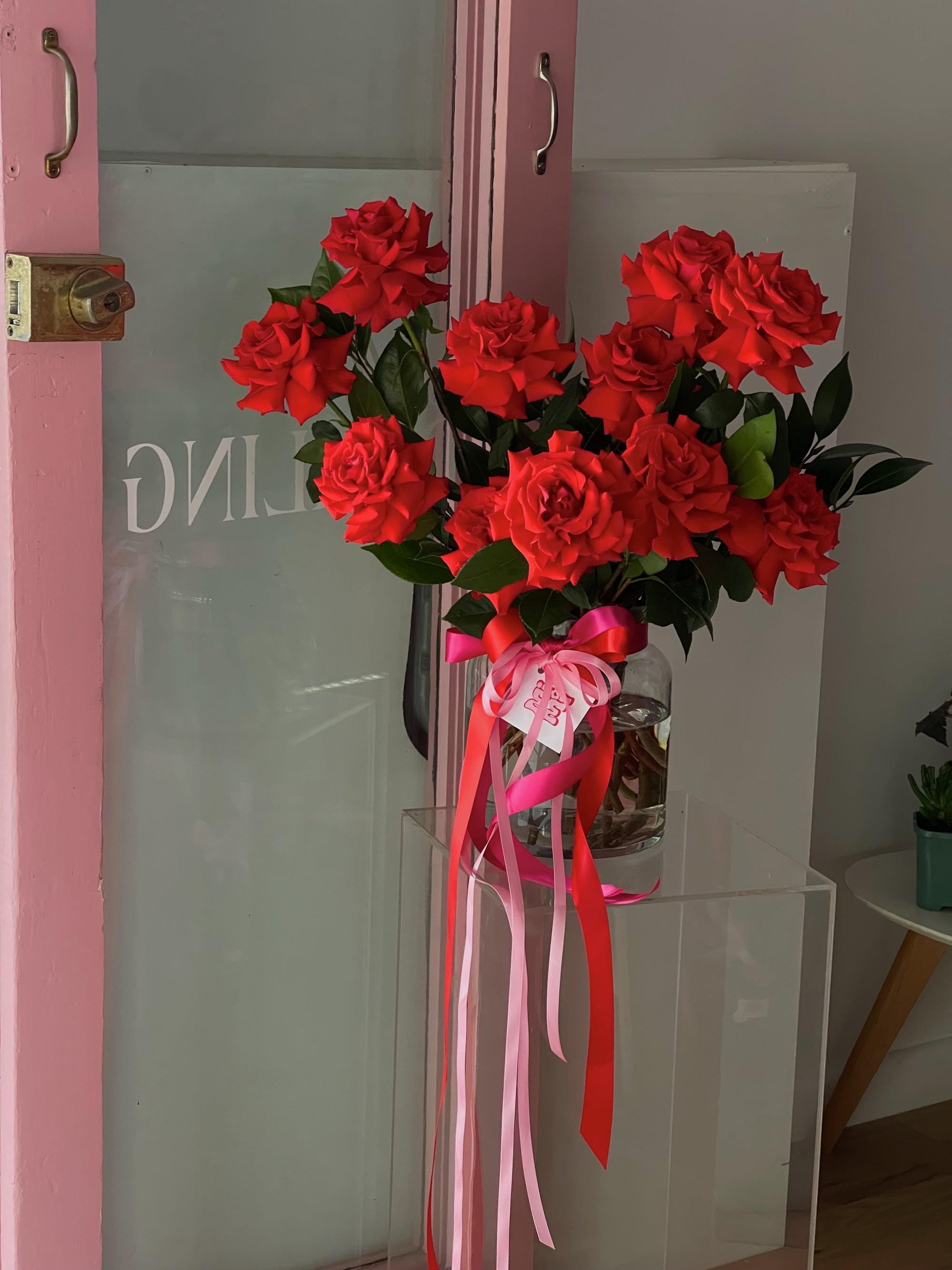 A vase of big bright red roses